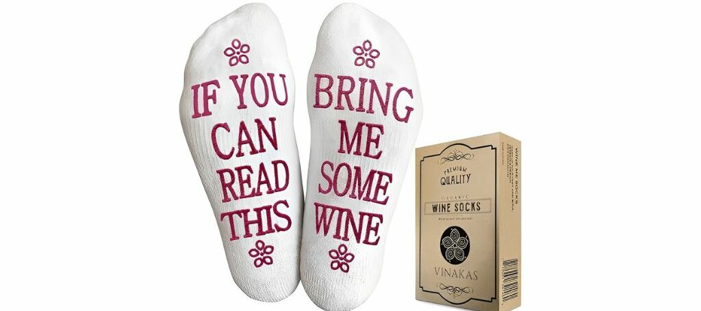White socks with 'If you can read this, bring me wine' and Vinakas packaging.