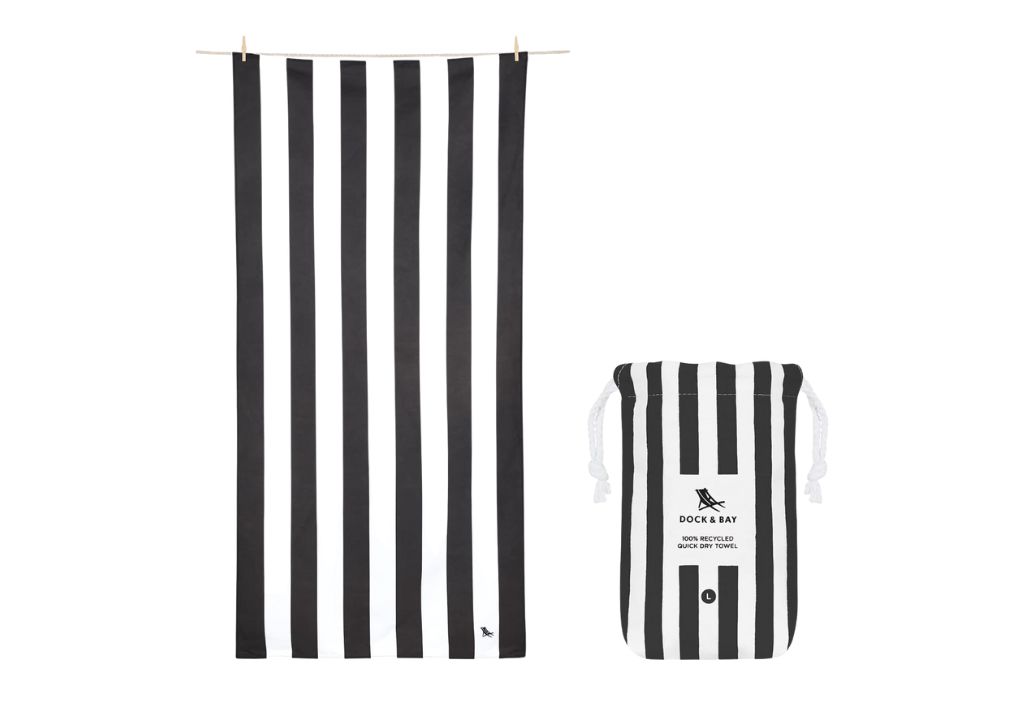 a black and white striped towel for the beach