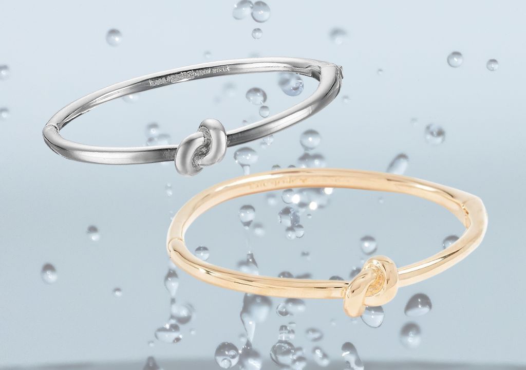 a pair of bracelets with a knot in gold and silver