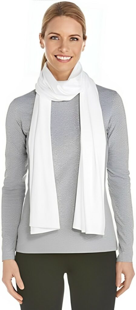 Woman wearing a lightweight, long-sleeved, white sun shawl with UPF 50+ protection.