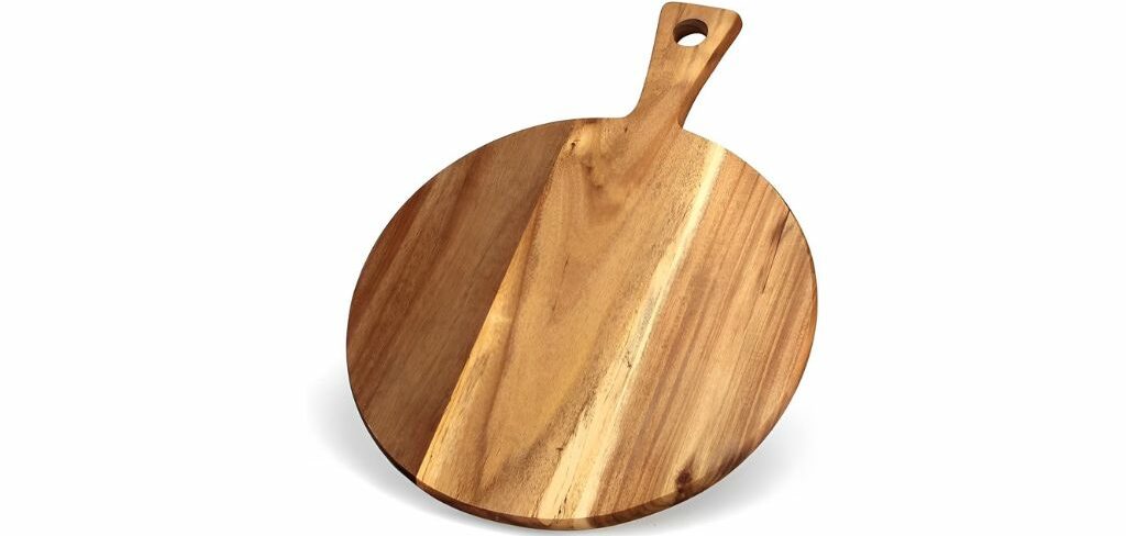 Round wooden pizza board with a handle and a natural finish.