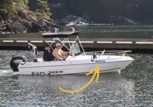 a boat showing the pleasure craft licence number on the bow