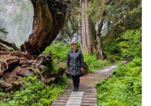 Woman standing on wooden hiking trail