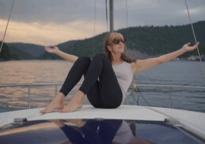 Woman practicing yoga on boat.