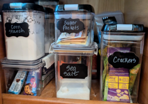 Labeled containers in galley cabinet