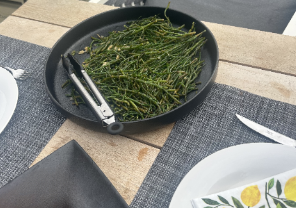 a plate of bright green sea asparagas on a table